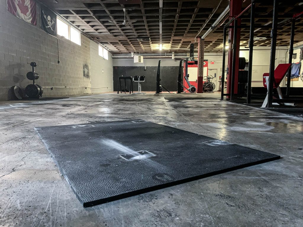 A 4 by 6 foot rubber horse stall mat on thee floor of a functional fitness gym in Winnipeg.