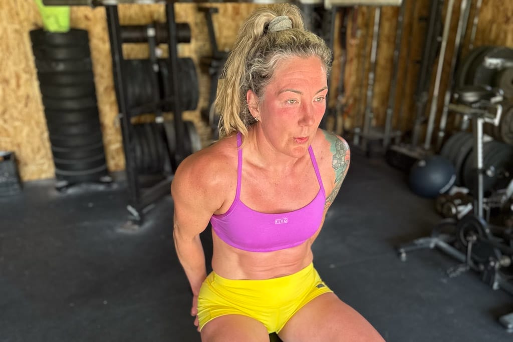 Crystal Kirby-Peloquin recovers in the gym after a summer workout.